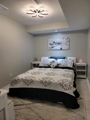 a bedroom with a bed and a ceiling fan at RoryHouse in Toronto