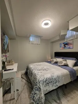 a bedroom with a bed and a desk in it at RoryHouse in Toronto