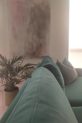 a green couch in a living room with a plant at GGP Boutique Townhome in Vaughan