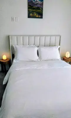 a white bed with white pillows on top of it at GGP Boutique Townhome in Vaughan