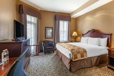 a hotel room with a bed and a flat screen tv at The Parlour Inn, an Ascend Collection Hotel in Stratford