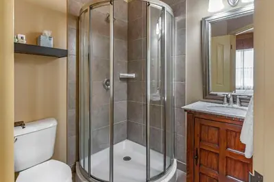 a bathroom with a shower and a toilet and a sink at The Parlour Inn, an Ascend Collection Hotel in Stratford