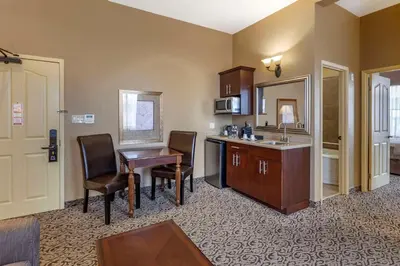 a kitchen with a desk and a table and chairs at The Parlour Inn, an Ascend Collection Hotel in Stratford
