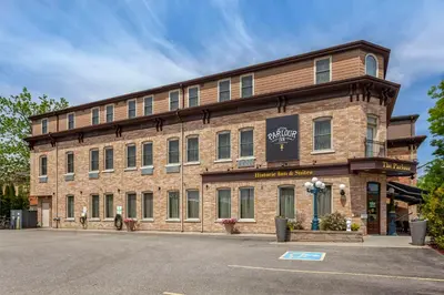 a large brick building with a sign on it at The Parlour Inn, an Ascend Collection Hotel in Stratford
