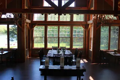 a dining room with tables and chairs and windows at Trillium Resort & Spa in Port Sydney