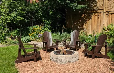 three chairs and a fire pit in a yard at Greater Toronto B&B in Oakville