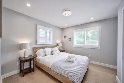 a bedroom with a bed with a stuffed animal on it at Lake view cottage with three ensuites and elevator in Fort Erie
