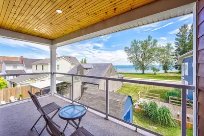 a balcony with a view of the ocean from a house at Lake view cottage with three ensuites and elevator in Fort Erie
