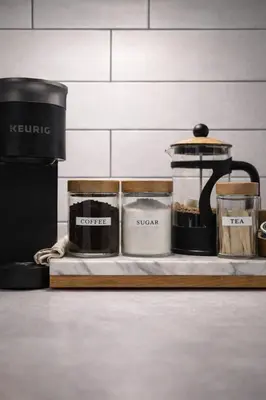 a table with several containers and a coffee pot on it at Lake view cottage with three ensuites and elevator in Fort Erie