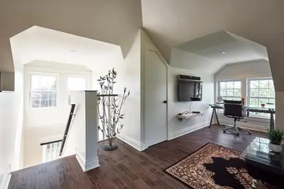 an open living room with a desk and a television at Bramasole Bed and Breakfast in Roseneath