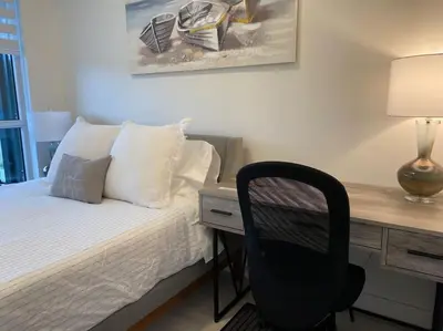 a bedroom with a desk and a chair next to a bed at 2 bedroom 2 bath Aquarius, Friday Harbour, Innisfil, Barrie in Innisfil