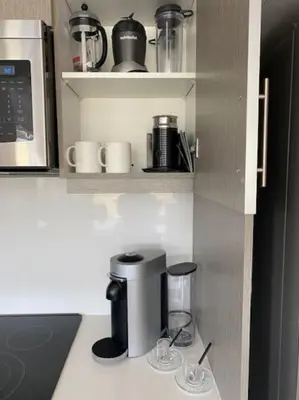 a kitchen with a coffee maker on a shelf at 2 bedroom 2 bath Aquarius, Friday Harbour, Innisfil, Barrie in Innisfil