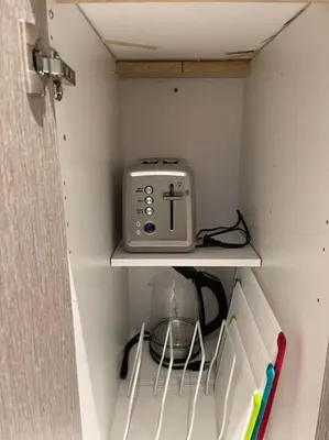 a small appliance is sitting on a shelf in a cabinet at 2 bedroom 2 bath Aquarius, Friday Harbour, Innisfil, Barrie in Innisfil