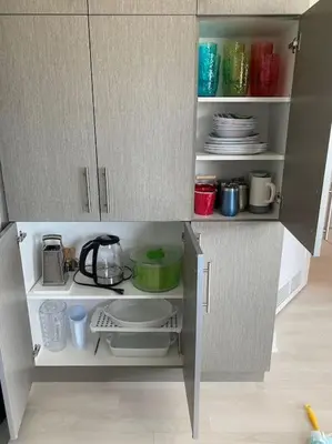 a model of a kitchen cabinet with plates and utensils at 2 bedroom 2 bath Aquarius, Friday Harbour, Innisfil, Barrie in Innisfil