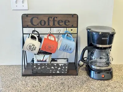 a coffee rack with a coffee maker on a counter at Blue Mountain at your Door Step in Blue Mountains