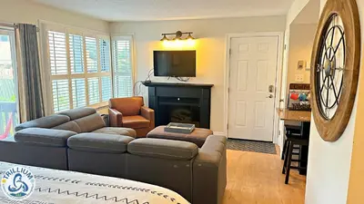 a living room with a couch and a fireplace at Blue Mountain at your Door Step in Blue Mountains