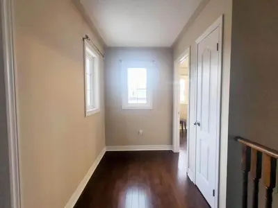 an empty hallway with a door and a window at Affordable Room with FREE Parking in Newmarket ON in Newmarket