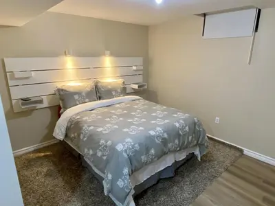 a bedroom with a bed with a headboard and pillows at Affordable Room with FREE Parking in Newmarket ON in Newmarket