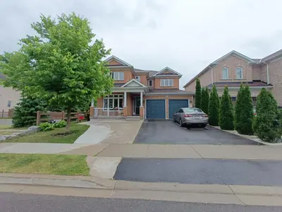 a house with a car parked in a driveway at Affordable Room with FREE Parking in Newmarket ON in Newmarket