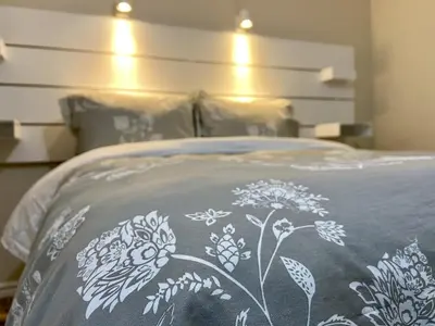 a bed with a blanket with flowers on it at Affordable Room with FREE Parking in Newmarket ON in Newmarket