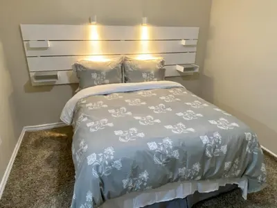 a bedroom with a bed with a headboard and pillows at Affordable Room with FREE Parking in Newmarket ON in Newmarket
