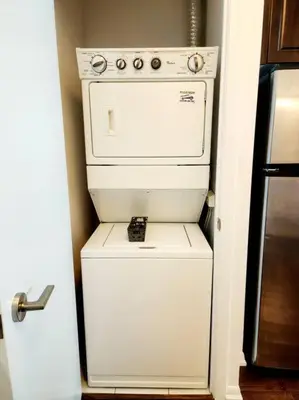 a white stove in a kitchen next to a refrigerator at Lakeview Condo in Downtown with Free Parking. in Toronto