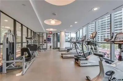 a gym with treadmills and elliptical machines at Lakeview Condo in Downtown with Free Parking. in Toronto