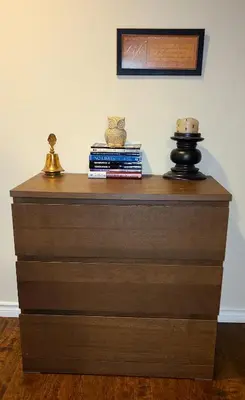 a wooden dresser with books on top of it at Spacious and bright unit with natural light. in Pickering