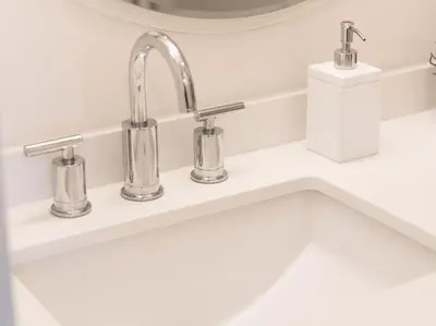 a bathroom sink with three faucets and a mirror at Pristine Modern 2BR Condo Private BBQ and Balcony in Toronto