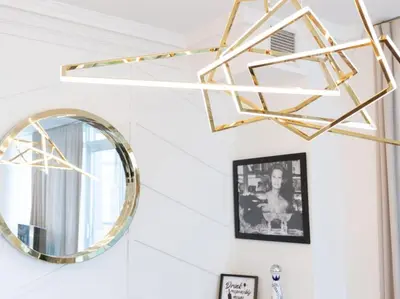 a mirror and a gold chandelier in a room at Pristine Modern 2BR Condo Private BBQ and Balcony in Toronto