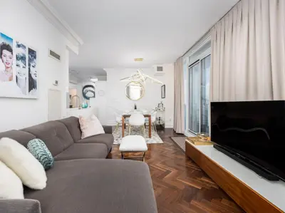a living room with a couch and a fireplace at Pristine Modern 2BR Condo Private BBQ and Balcony in Toronto