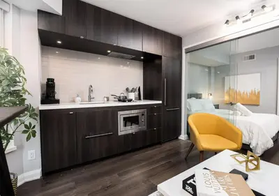 a kitchen with a sink and a bed in a room at One of Toronto s finest 1BR Condo with a WFH Setup in Toronto