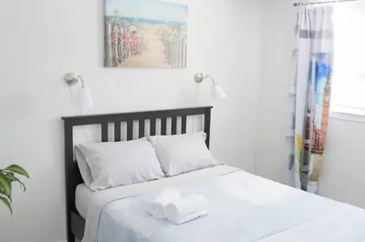 a bedroom with a bed with a towel on it at Richview Gardens Suite, 3-bdr in Toronto