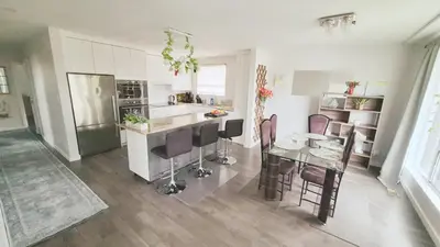 a kitchen with a table and chairs in a room at Richview Gardens Suite, 3-bdr in Toronto
