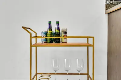 a shelf with wine bottles and wine glasses on it at Oshawa Family Haven - Luxury 7BR Villa with Cozy Fireplaces & Hot Tub in Oshawa