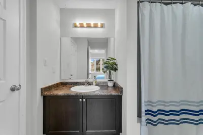 a bathroom with a sink and a mirror at Oshawa Family Haven - Luxury 7BR Villa with Cozy Fireplaces & Hot Tub in Oshawa