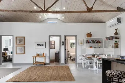 a living room with white walls and a wooden ceiling at The Barns of Brighton Near Prince Edward County in Brighton