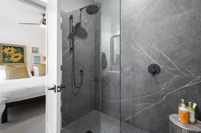 a shower with a glass door in a bedroom at The Barns of Brighton Near Prince Edward County in Brighton