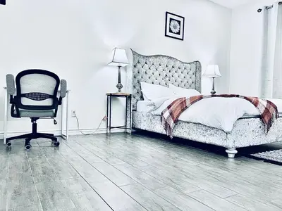 a bedroom with a bed and a chair at Lavida Luxury Room #1 in London in London
