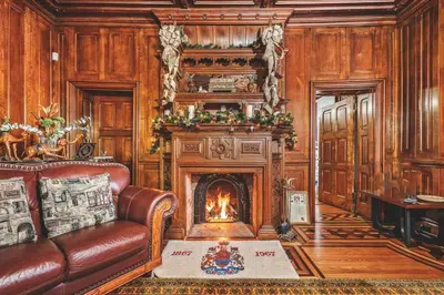 a living room with a couch and a fireplace at Lakehurst Estate in Cobourg