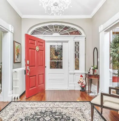 a red door in a living room with a table at Lakehurst Estate in Cobourg