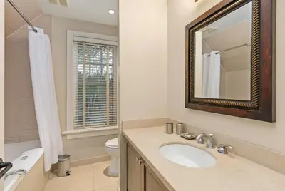 a bathroom with a sink and a mirror and a toilet at Lakeside at Rocky Crest Resort and Golf Club on Joseph Lake in Rosseau
