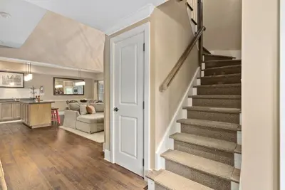 a staircase in a home with a living room at Lakeside at Rocky Crest Resort and Golf Club on Joseph Lake in Rosseau