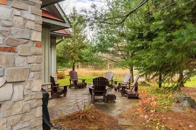 a group of chairs sitting on a patio at Lakeside at Rocky Crest Resort and Golf Club on Joseph Lake in Rosseau