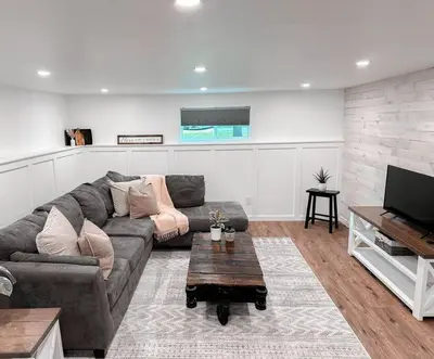 a living room with a couch and a tv at The Victoria Suite in Elora- King Bed in Elora