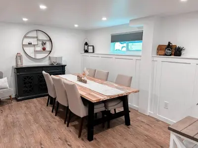 a dining room table with chairs and a mirror at The Victoria Suite in Elora- King Bed in Elora