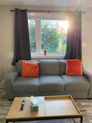 a living room with a couch and a window at ENTIRE 2 BEDROOM APARTMENT DOWNTOWN - u5 in Waterloo