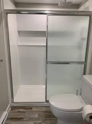 a bathroom with a toilet and a glass shower at ENTIRE 1 BEDROOM APARTMENT DOWNTOWN - u4 in Waterloo