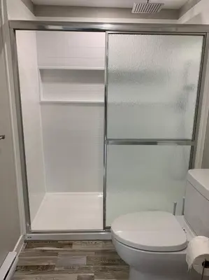 a bathroom with a toilet and a glass shower at ENTIRE 1 BEDROOM APARTMENT DOWNTOWN - u4 in Waterloo