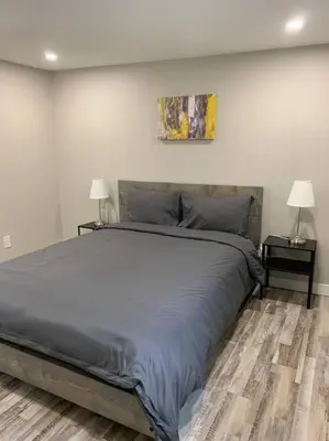 a bedroom with a large bed with two night stands at ENTIRE 1 BEDROOM APARTMENT DOWNTOWN - u4 in Waterloo